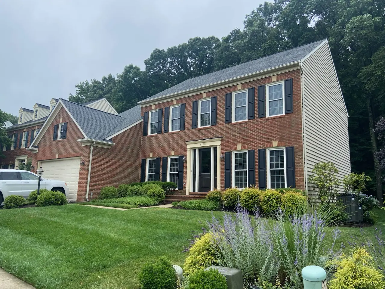 Brick colonial with blue shutters