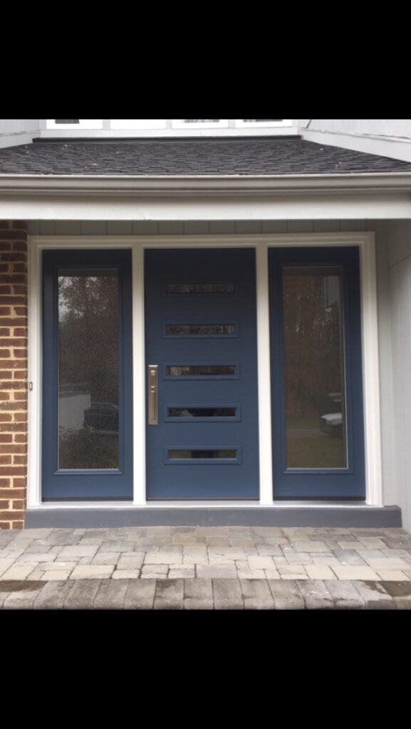 Modern blue front entry door with horizontal slot windows and full-height sidelights.