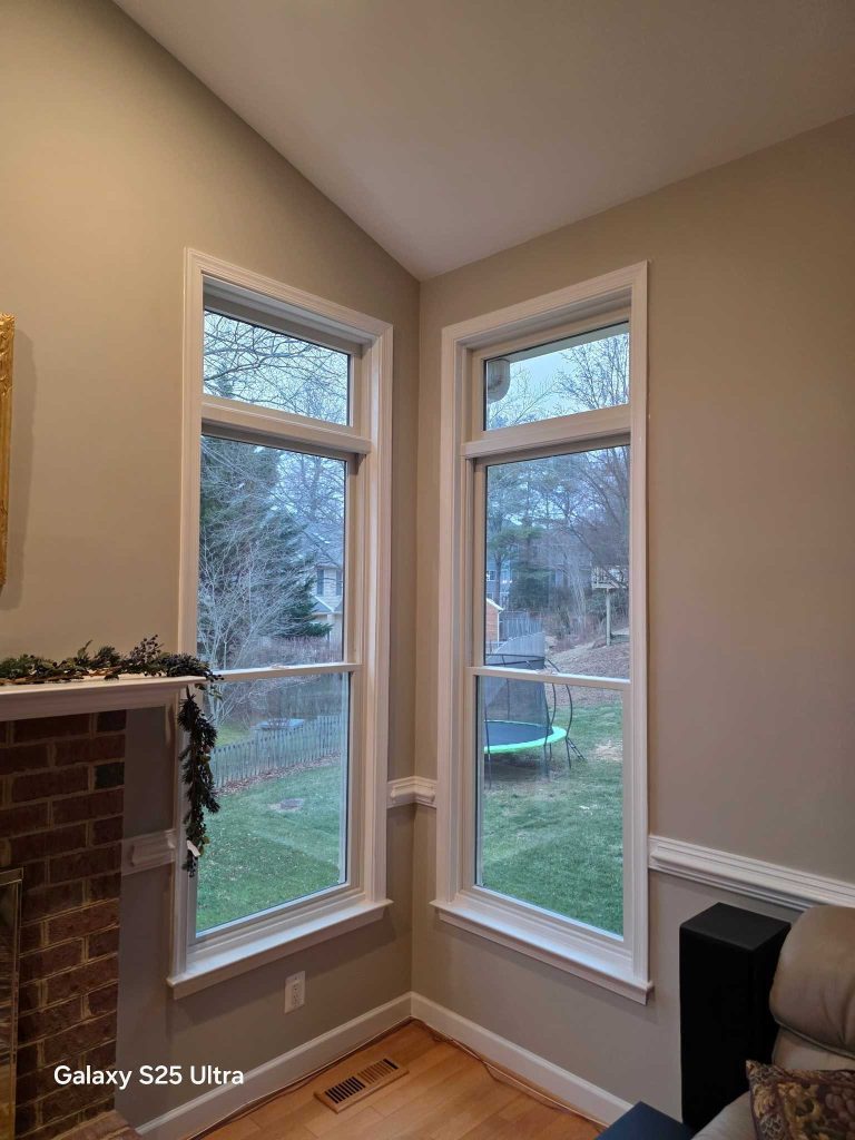 New Andersen double-hung windows installed in a corner living space by Virginia Exteriors