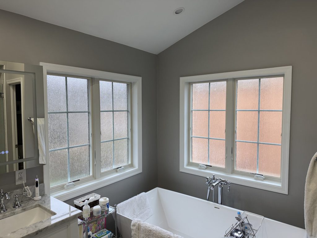 Andersen casement windows with waterfall obscure glass in a primary bath, installed by Virginia Exteriors